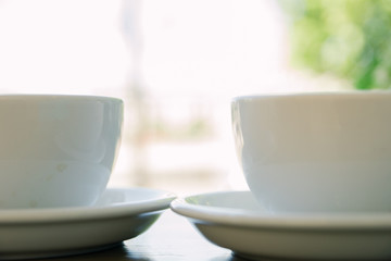 two cups of fresh cappuccino coffee on the table in summer cafe