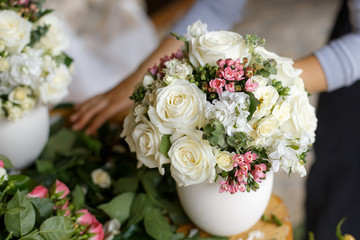 Wedding arrangements with a mix of fresh flowers in white vases