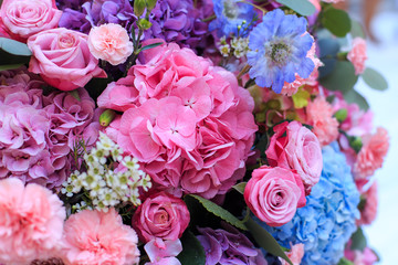 Pink and purple hydrangea, eucalyptus, pink roses, carnations and chrysanthemums.