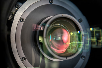 close up of a television lens on a dark background