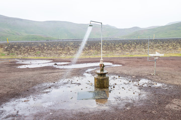 Fototapeta na wymiar Krafla shower. Geothermal valley Leirhnjukur, a tourist attraction of Iceland
