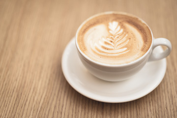 Hot coffee cappuccino latte art on wooden background