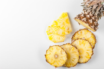 Pineapple fruit on a white background. Pineapple on the kitchen board with a knife slices