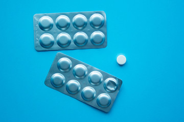 Some medical blisters and 1 pill top view. Medical concept of treatment diseases, sale of tablets, tablets in blister packs.