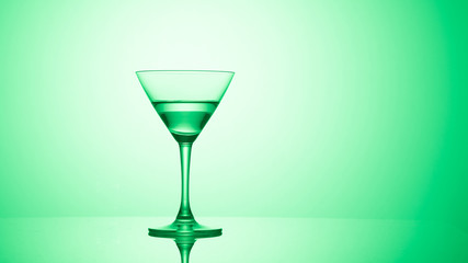 Martini glass on color background