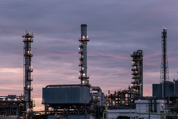 Petroleum oil refinery plant beside river in twilight time. Crude Oil Process machinery