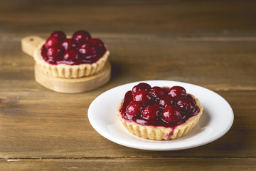 Small Homemade Tarts with Fresh Cherries on a Wooden Background Tartlets with Cherry Tasty Dessert