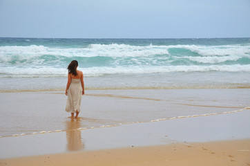 Girl Wearing a Dress Walking by a Long Sand Beach in Fuerteventura, Canary Islands