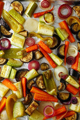 Fototapeta na wymiar Roasted vegetables mix on baking tray, food above. Vegan food