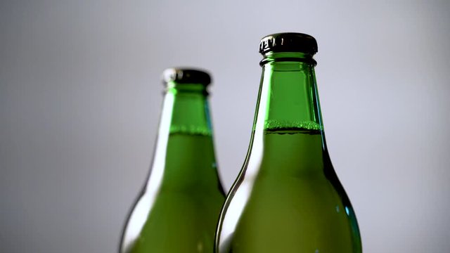 Play of studio light on green beer bottles close-up