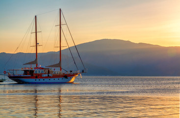 Yacht on the background of the sea and mountains.