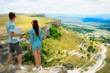 Naklejka premium Holidays in the mountains. Young attractive couple.