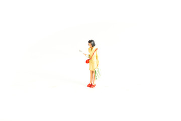 Miniature Person Reading a Paper Dressed in Yellow Standing on a White Isolated Background