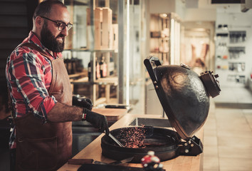 Chef preparing charcoals before grilling in a restaurant