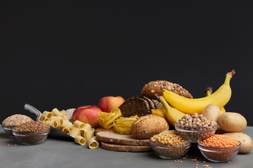 Set of organic food with healthy carbohydrates on black