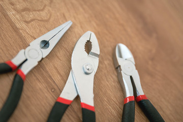 Construction tools on the wooden background.