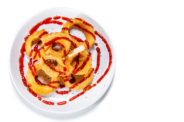 Onion rings with sauce on white background 