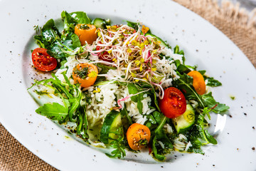 Salad with white rice on wooden background