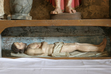 Fototapeta na wymiar Jesus in the tomb, Altar of the Passion of Christ in the Church of Assumption in Sveta Marija na Muri, Croatia 