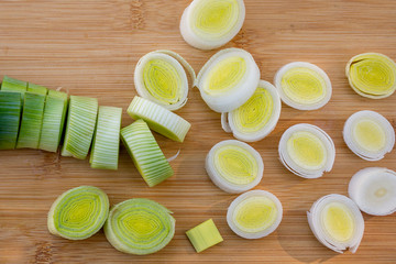 Organic fresh cutted leeks on the wooden cutting board. Leek cut by means rings on a chopping...