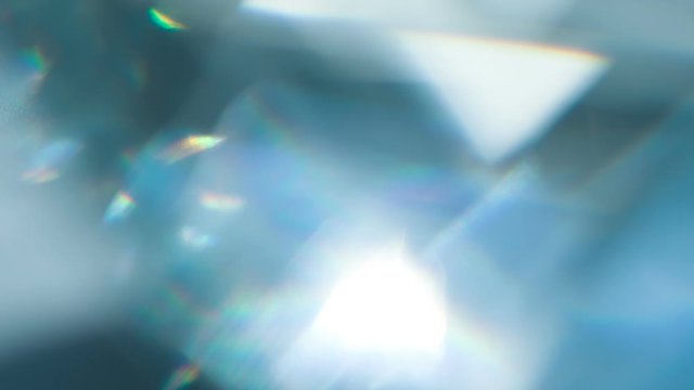 Sparkling Diamond Highlights. Loop. The light passes through the facets of a slowly rotating diamond and creates repetitive sparkling highlights and rainbow colors