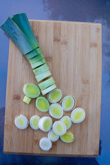 Organic fresh cutted leeks on the wooden cutting board. Leek cut by means rings on a chopping...