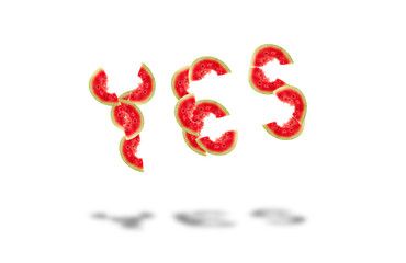 word yes laid out from pieces of ripe red watermelon with seeds isolated on white background
