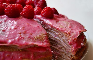 Pancake cake with raspberries and raspberry cream.