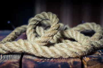 Thick jute rope on a brutal wooden table. Thematic design of the local bar. Shooting at eye level....