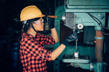 Asian beuatiful woman working with machine in the factory engineer and working woman concept or...