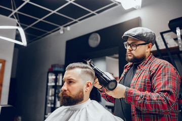 Man with a beard. Hairdresser with a client. Man in a red shirt