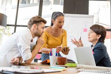 Group of casual business meeting to discuss ideas and computer laptop on table in office.