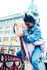 Two teenage girls infront of university building smiling, having fun, lifestyle real people concept close up