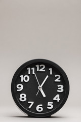Close-up of a black alarm clock on plain background
