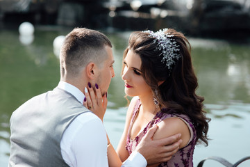 Summer holidays, love, romance and people concept - happy smiling young  couple hugging outdoors near lake. Enjoy moment of happiness and having fun. Love story. Couple in love.