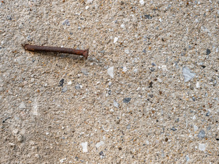 Texture. Texture. Rusty nail in plastered surface. Still life. Close-up.