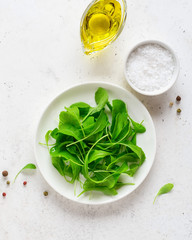 Healthy green salad of fresh arugula. Health care, detox, fitness, diet concept.