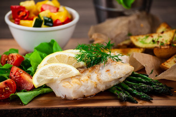 Fish dish - fried fish fillet with fried potatoes and vegetables