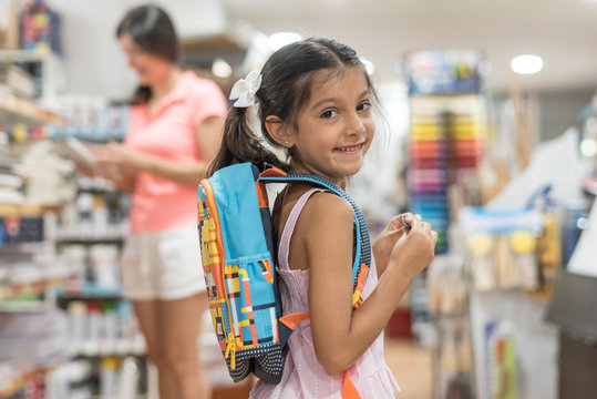 Mother and daughter buying school supplies preparing to go back to school