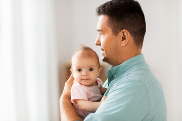 family, parenthood and fatherhood concept - middle aged father with little baby daughter at home