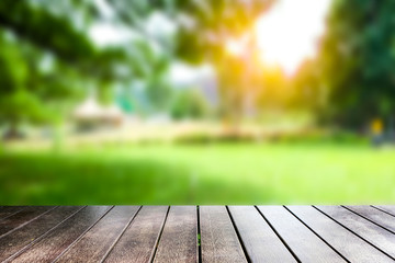 Empty plank, blurred background, green garden For placing  products