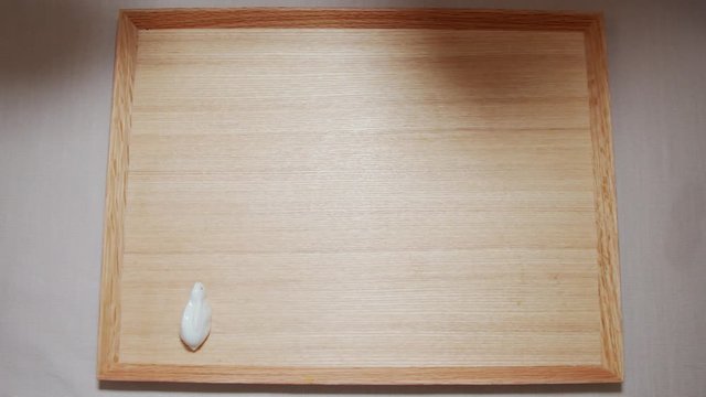 A Japanese female chef setting the Japanese meal at home kitchen, Tokyo, Japan. May 2019. Camera fixed, extreme close-up, birds eye view shot.