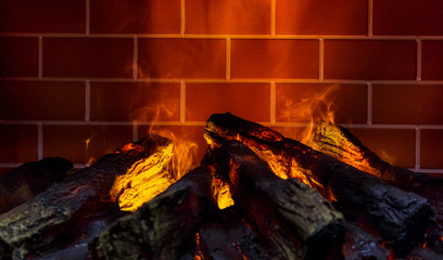 red brick fireplace on fire