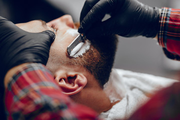 Man with a beard. Hairdresser with a client.