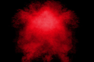 Red orange color powder explosion cloud  on black background.
