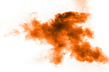 Abstract orange dust explosion on white background. Abstract orange powder splattered on white background.