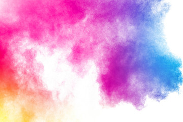 Abstract multi color powder explosion on white background.Freeze motion of dust particles splash.