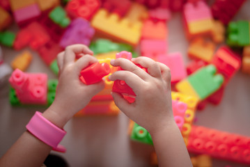 Children toddlers play toys at home.