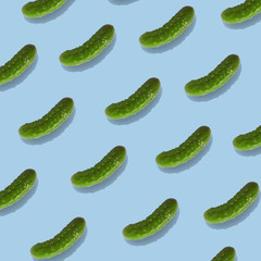 Pattern with pickled gherkins on blue background. Fashionable cucumber pattern.