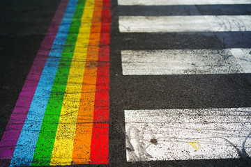 Road marking of pedestrian crossing and rainbow flag in Paris. Sex discrimination concept....